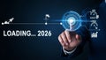 Businessman touching futuristic screen loading 2026 with rocket and charts image Royalty Free Stock Photo