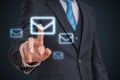 Businessman is touching mail symbol with finger on futuristic screen Royalty Free Stock Photo