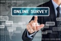 Businessman touching ONLINE SURVEY button on virtual screen