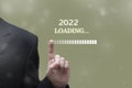 Businessman touching progress bar. Loading 2022 new year concept Royalty Free Stock Photo