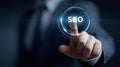 Businessman touching screen button activating seo search engine optimization Royalty Free Stock Photo
