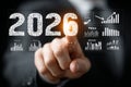 Businessman touching virtual screen displaying year 2026 and various data charts, symbolizing planning and future strategy Royalty Free Stock Photo