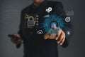Businessman touching virtual screen interface with AI chip, cybersecurity lock, cloud computing and data analytics icons. Royalty Free Stock Photo