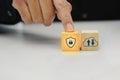 Businessman touching a wooden block cube with various icon symbol. Safety protection and technology concept. Royalty Free Stock Photo