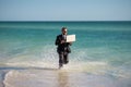 Businessman tourist in casual suit barefoot walking on tropical beach with laptop. Handsome business man on summer Royalty Free Stock Photo