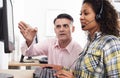 Businessman Training Female Employee Wearing Headset In Call Centre Office