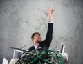 Businessman trapped by cables. concept of stress and overwork