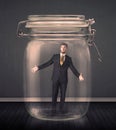 Businessman trapped into a glass jar concept Royalty Free Stock Photo