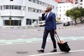 Businessman traveling and talking on cell phone Royalty Free Stock Photo