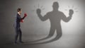 Businessman fighting with his unarmed shadow