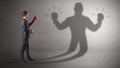 Businessman fighting with his unarmed shadow