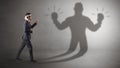 Businessman fighting with his unarmed shadow