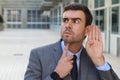 Businessman trying to hear a gossip Royalty Free Stock Photo