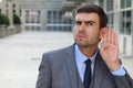 Businessman trying to hear a gossip Royalty Free Stock Photo