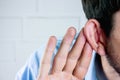 Businessman trying to hear gossip Royalty Free Stock Photo