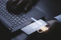 Businessman typing on keyboard laptop computer and holding smartphone to input username and password for or technology security