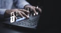 Businessman typing on keyboard laptop computer to input username and password for technology security system and prevent hacker Royalty Free Stock Photo