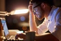 Businessman typing on laptop at night office