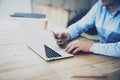 Businessman typing message smartphone. Generic design laptop on the table. Working hard new project. Blurred background