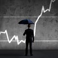 Businessman with umbrella standing over diagram background. Business, insurance, risk, concept. Royalty Free Stock Photo