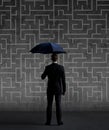 Businessman with umbrella standing over labyrinth background. Business, strategy, insurance, concept. Royalty Free Stock Photo