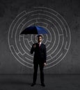 Businessman with umbrella standing over labyrinth background. Business, strategy, insurance, concept. Royalty Free Stock Photo