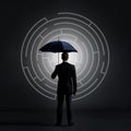 Businessman with an umbrella on a labyrinth