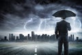 Businessman With Umbrella Looking Storm