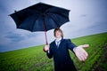 Businessman with umbrella outstretching hand Royalty Free Stock Photo