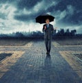 Businessman, umbrella and walking for security in rain, insurance at crossroads by city background for choice. Mature