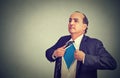 Businessman unbuttons his suit shirt becomes a super hero Royalty Free Stock Photo