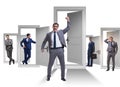 Businessman in uncertainty concept with many doors Royalty Free Stock Photo
