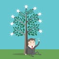 Businessman under lightbulbs tree Royalty Free Stock Photo