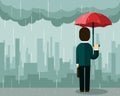 Businessman under rain with umbrella