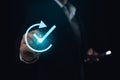 Businessman use digital pen touching Virtual blue Checkmark. Hand of a businessman interacting with a glowing green checkmark