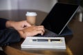 Businessman use the keyboard laptops for work in cafe