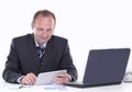 Businessman uses a digital tablet while sitting at his Desk