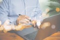 Businessman uses a pen to sign an electronic signature approved on an electronic document with a laptop on a wooden table. Royalty Free Stock Photo