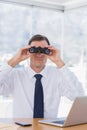 Businessman using binoculars in front of the camera Royalty Free Stock Photo