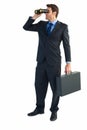 Businessman using binoculars while holding a briefcase