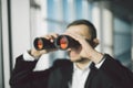 Businessman using binoculars in office Royalty Free Stock Photo
