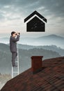Businessman using binoculars on property ladder over roof with home icon Royalty Free Stock Photo