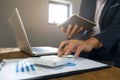 Businessman using calculator analyzing on company profits at a modern office Royalty Free Stock Photo