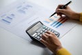 Businessman using a calculator to calculate numbers on a company's financial documents. Royalty Free Stock Photo