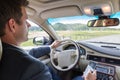 Businessman using cell phone and texting while driving not paying attention to the road. Royalty Free Stock Photo