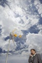 Businessman Using Cellphone Against Satellite Tower And Clouds Royalty Free Stock Photo