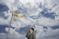 Businessman Using Cellphone Against Satellite Tower And Clouds Royalty Free Stock Photo