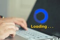 Businessman using computer keyboard with virtual loading icon