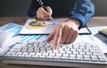 Businessman using computer keyboard and working in financial graphs Royalty Free Stock Photo