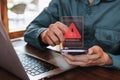 Businessman using computer laptop and smartphone with caution warning sing for notification error and virus detection spyware